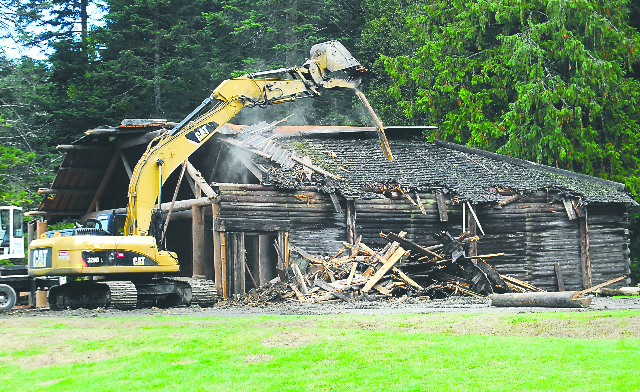 An excavator tears pieces from the longhouse in Lincoln Park in Port Angeles on Tuesday as the building is demolished. To see what’s left Wednesday