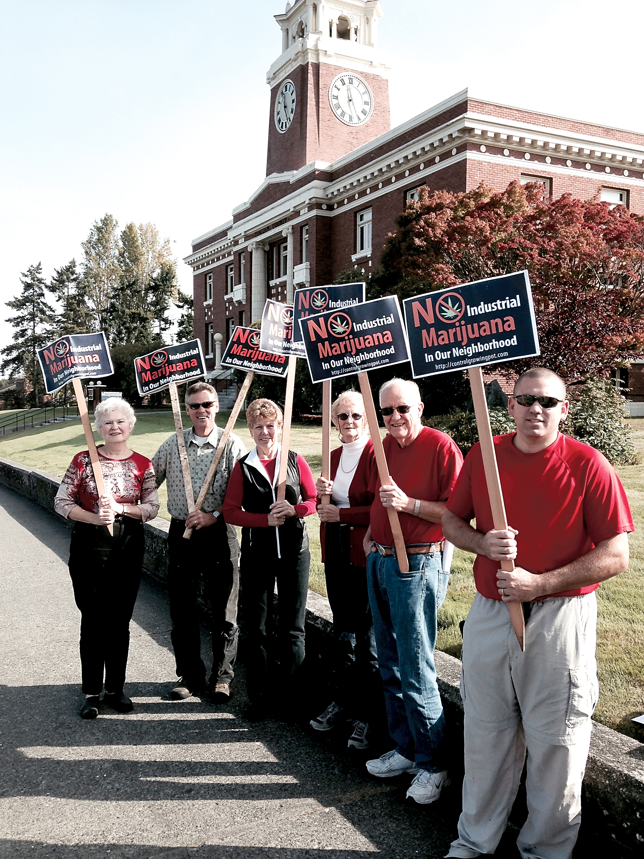 A group of demonstrators against industrial marijuana in rural residential neighborhoods stand outside the Clallam County Courthouse. From left are Lynne Clark
