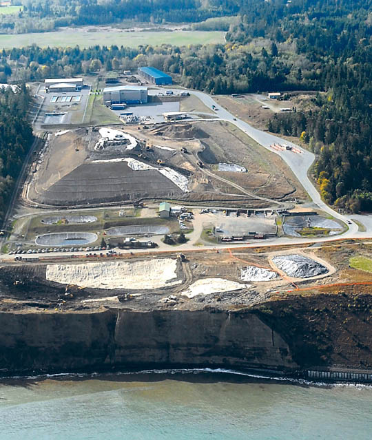 The former Port Angeles landfill undergoes transformation in a project to relocate buried refuse near the bluff to a mound farther inland as shown in an aerial photo taken Oct. 2. Keith Thorpe/Peninsula Daily News