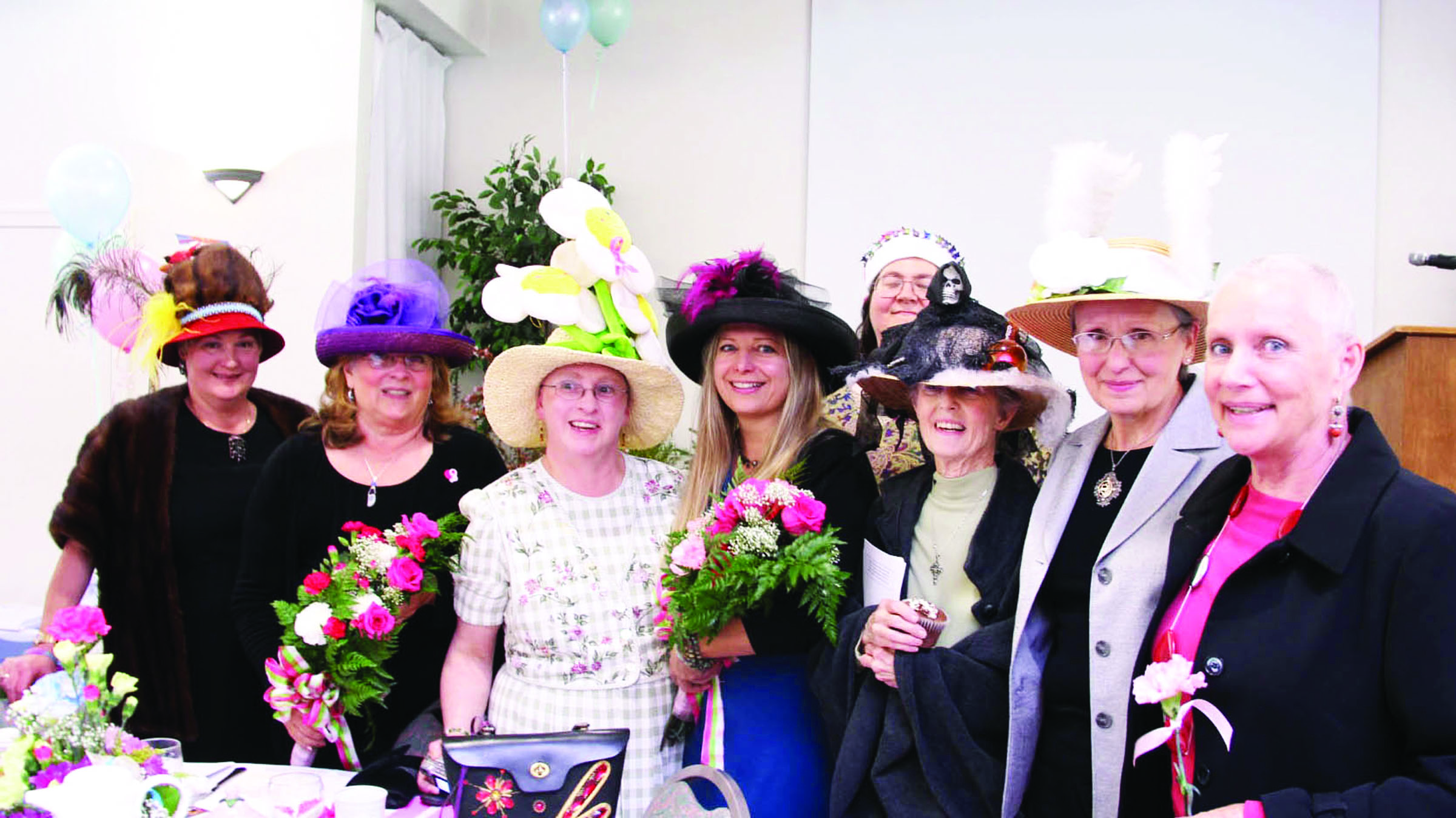 Members of the Olympic Medical Center Women's Cancer Support Group pause at the 15th annual Mad Hatter's Tea at SunLand Golf & Country Club on Friday. The group