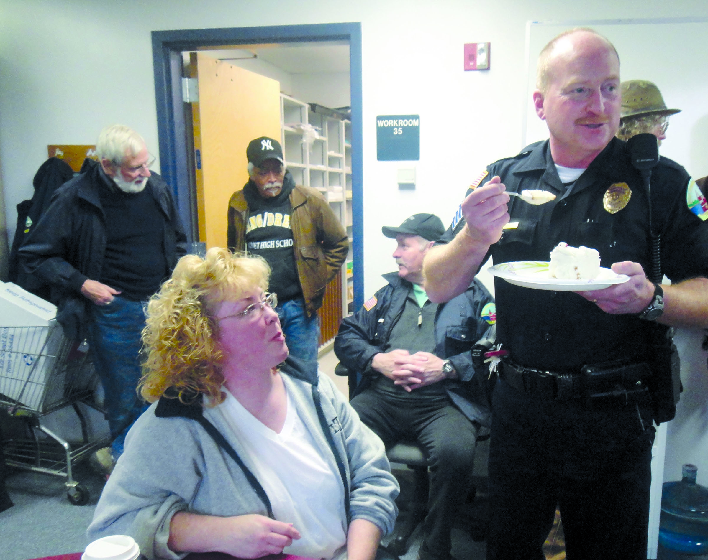 Port Townsend Police Sgt. Ed Green eats cake during a surprise going-away lunch on Friday with members of the department and city staff. His wife