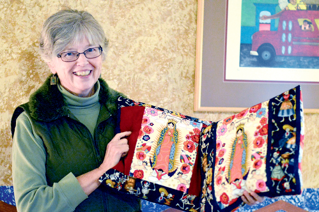 Judith Pasco of the Mujeres de Maiz Opportunity Foundation shows off Lyell Fox's pillows