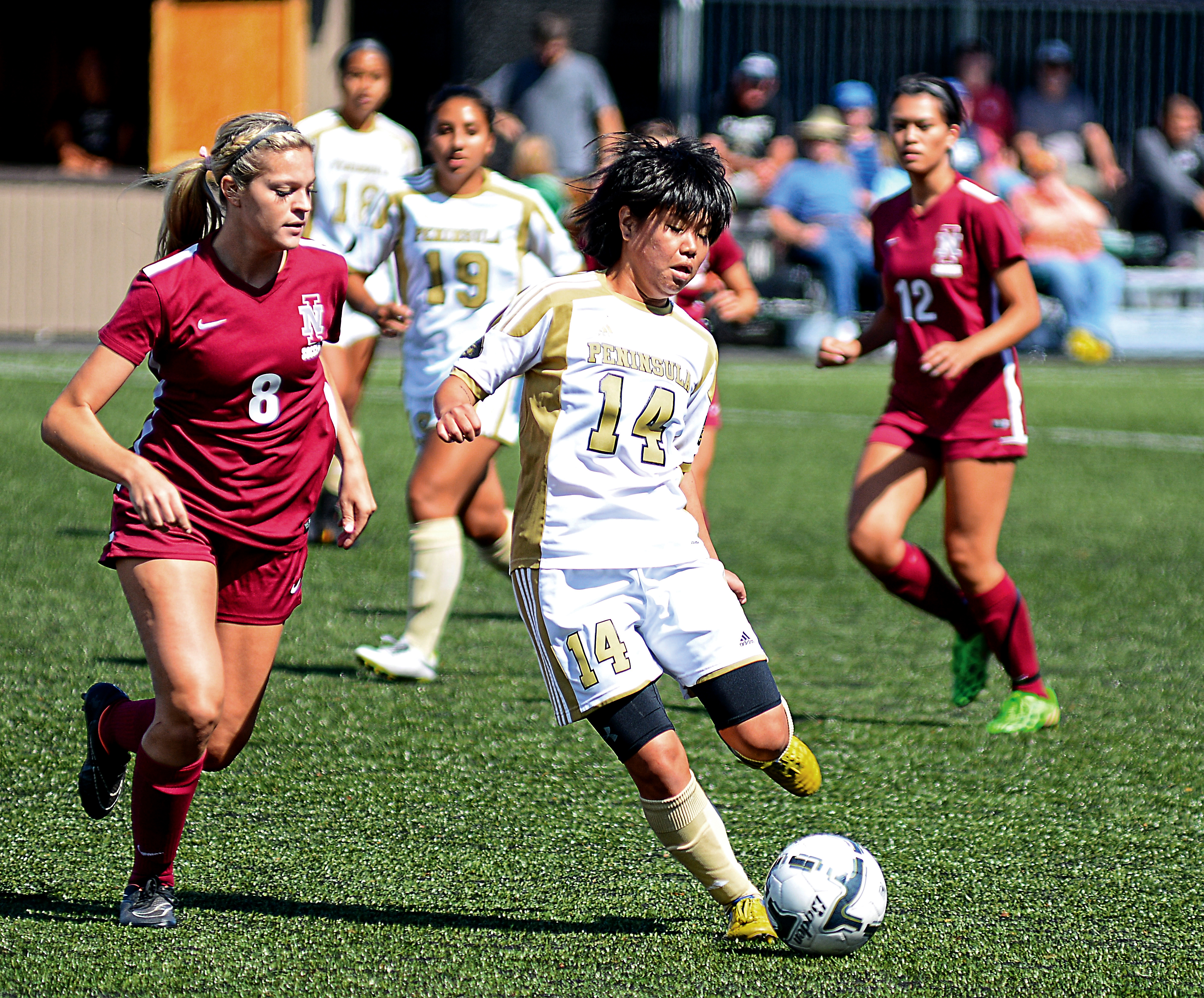 Peninsula's Myu Ban (14) is defended by North Idaho's Aitana Vernon during the Pirates' 5-0 win in September. Jay Cline