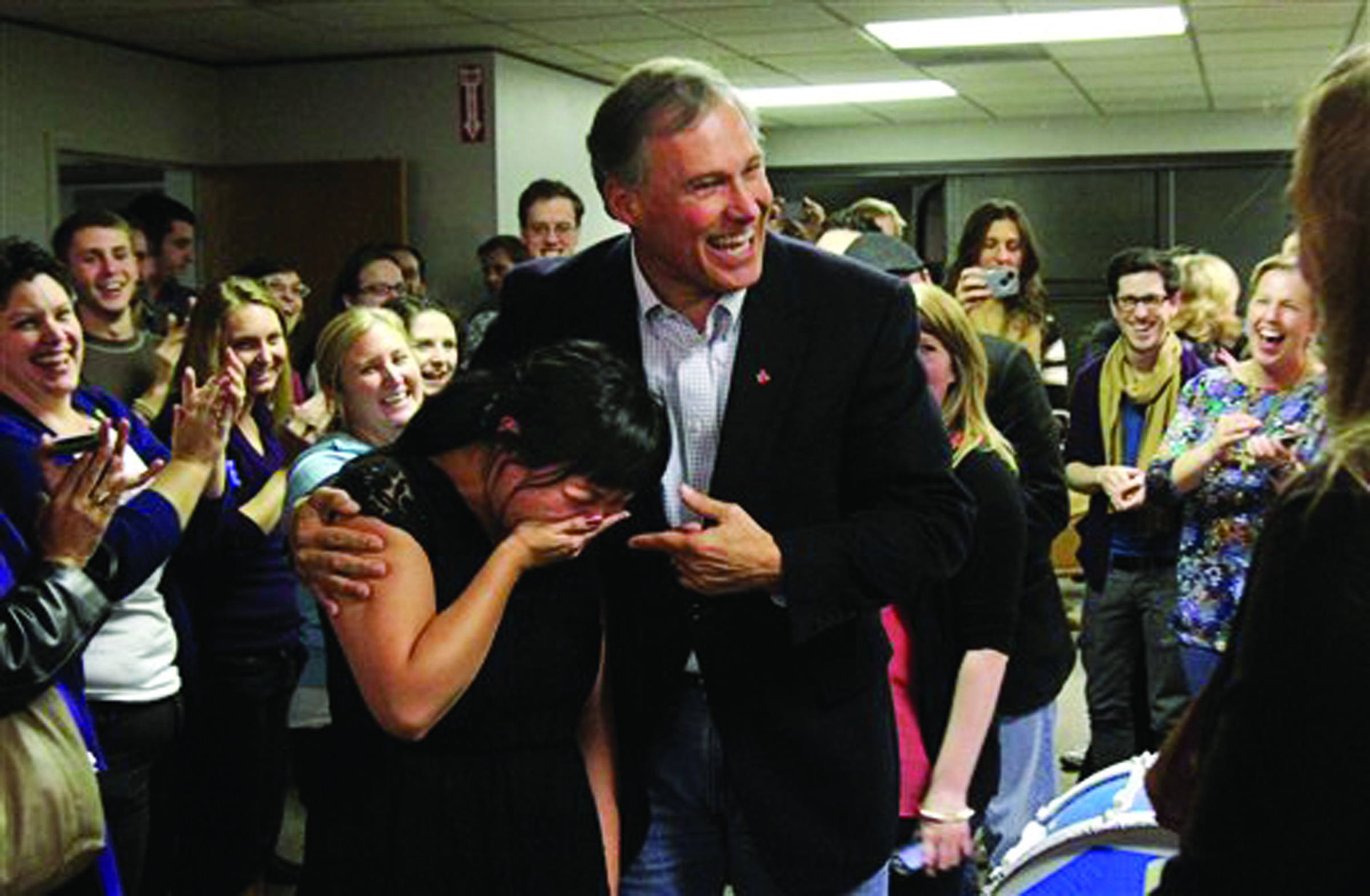 Jay Inslee puts his arm around Unjin Lee