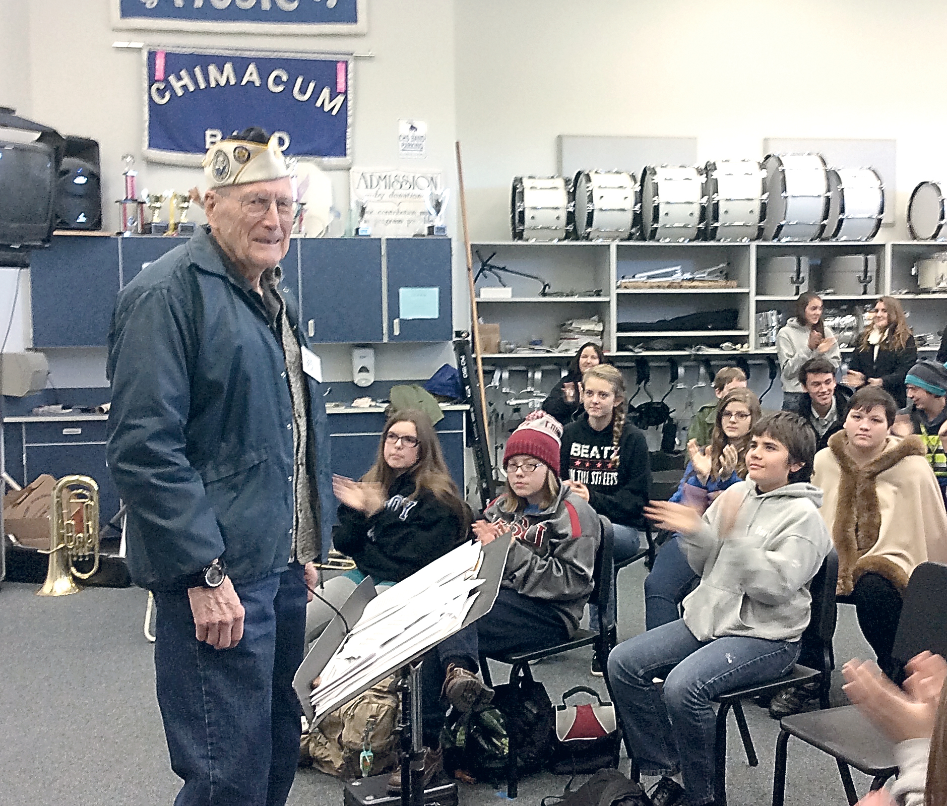 Pearl Harbor veteran Tom Berg gets applause for his firsthand account of the 1941 attack from Chimacum High School Band members. — Charlie Bermant/Peninsula Daily News