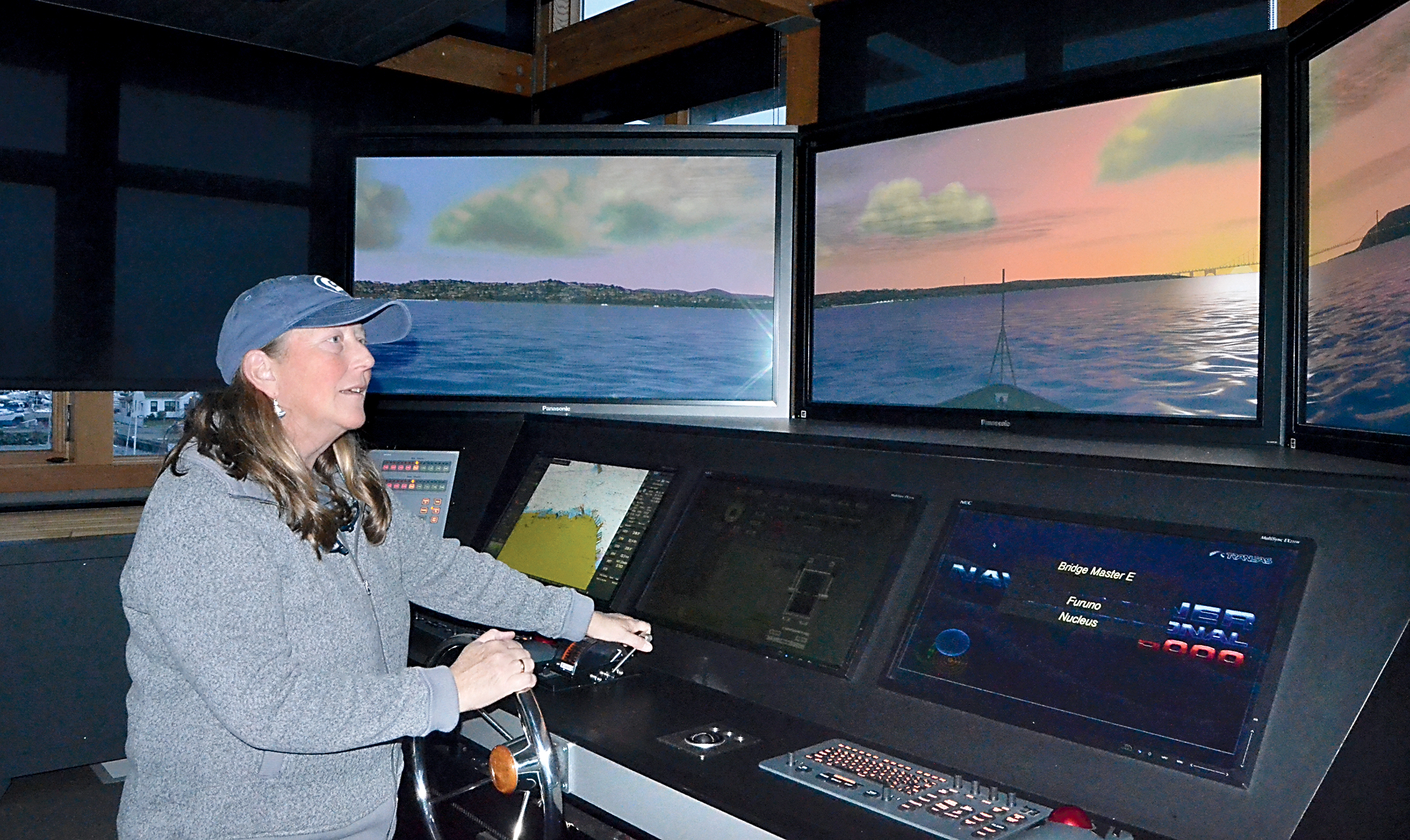 Northwest Maritime Center Waterfront Programs Manager Carolyn Spragg tests the Pilothouse Simulator in advance of Wednesday’s public program. — Charlie Bermant/Peninsula Daily News