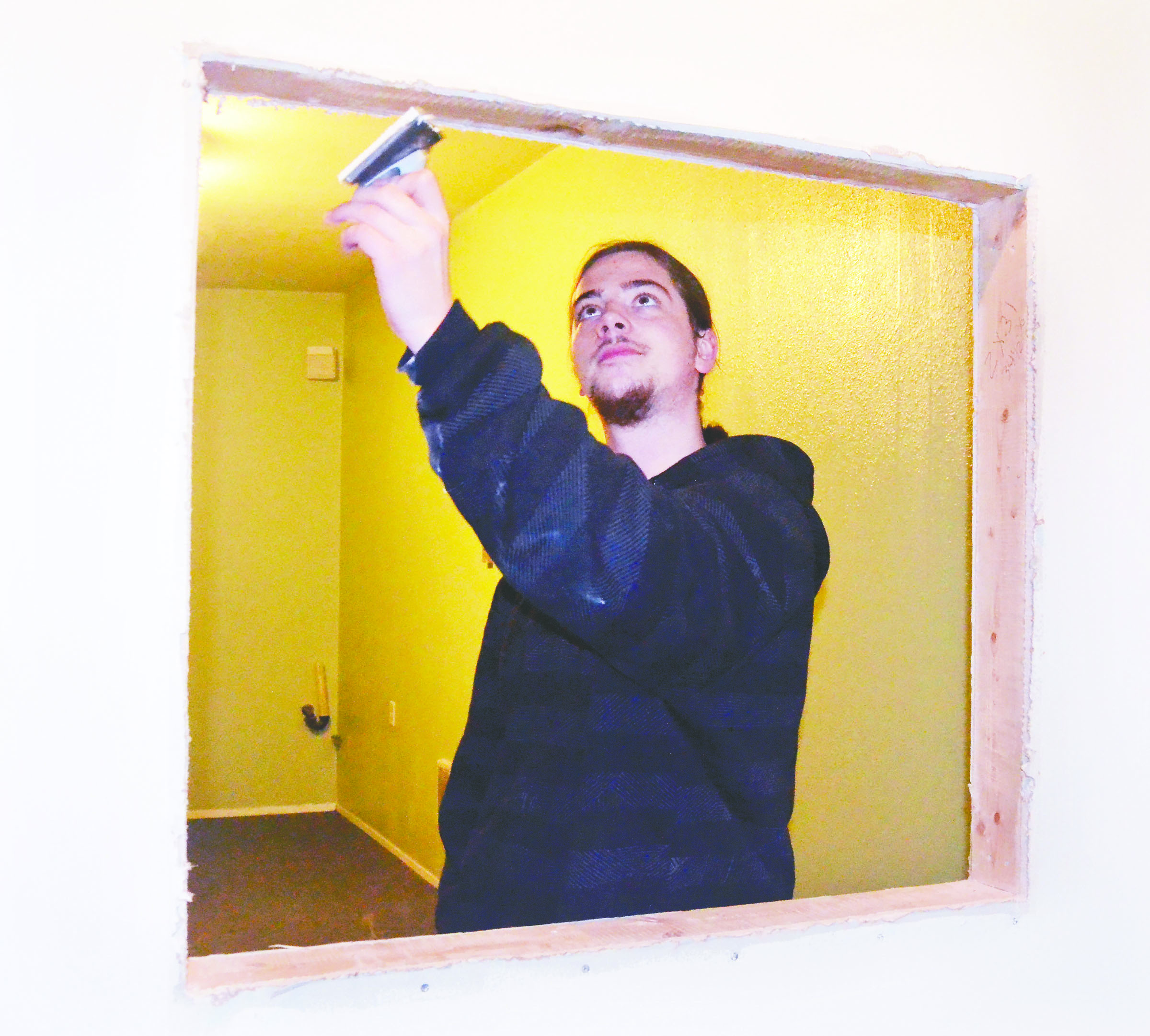 Gracen Hook prepares the service window in a medical pot dispensary he is opening in Port Townsend within the next few weeks. Hook