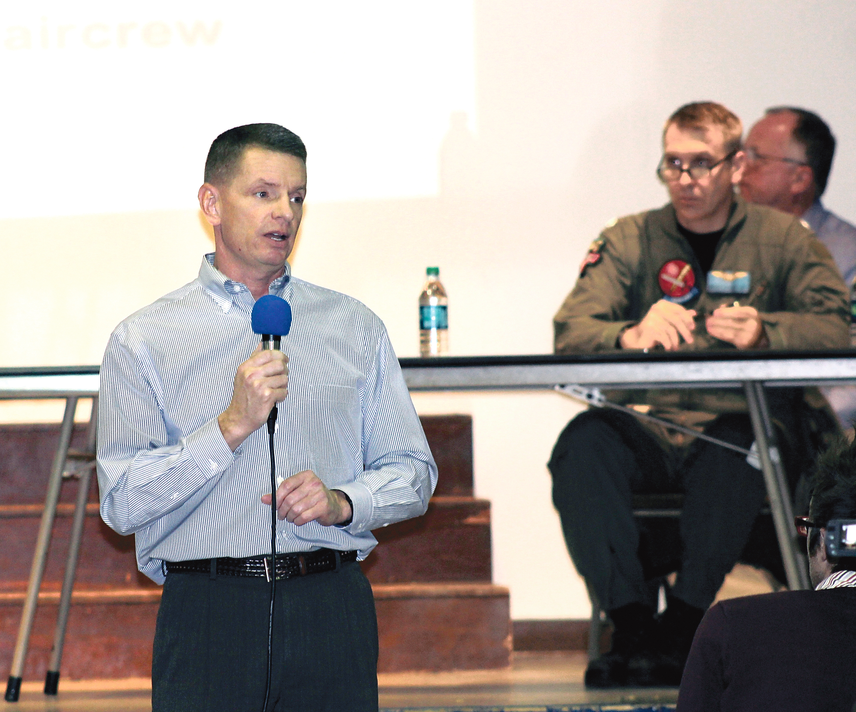 The Navy's John Mosher describes the plan to expand electronic warfare training in and around Pacific Beach and Olympic National Forest with Navy pilot Brian Davis looking on. North Coast News