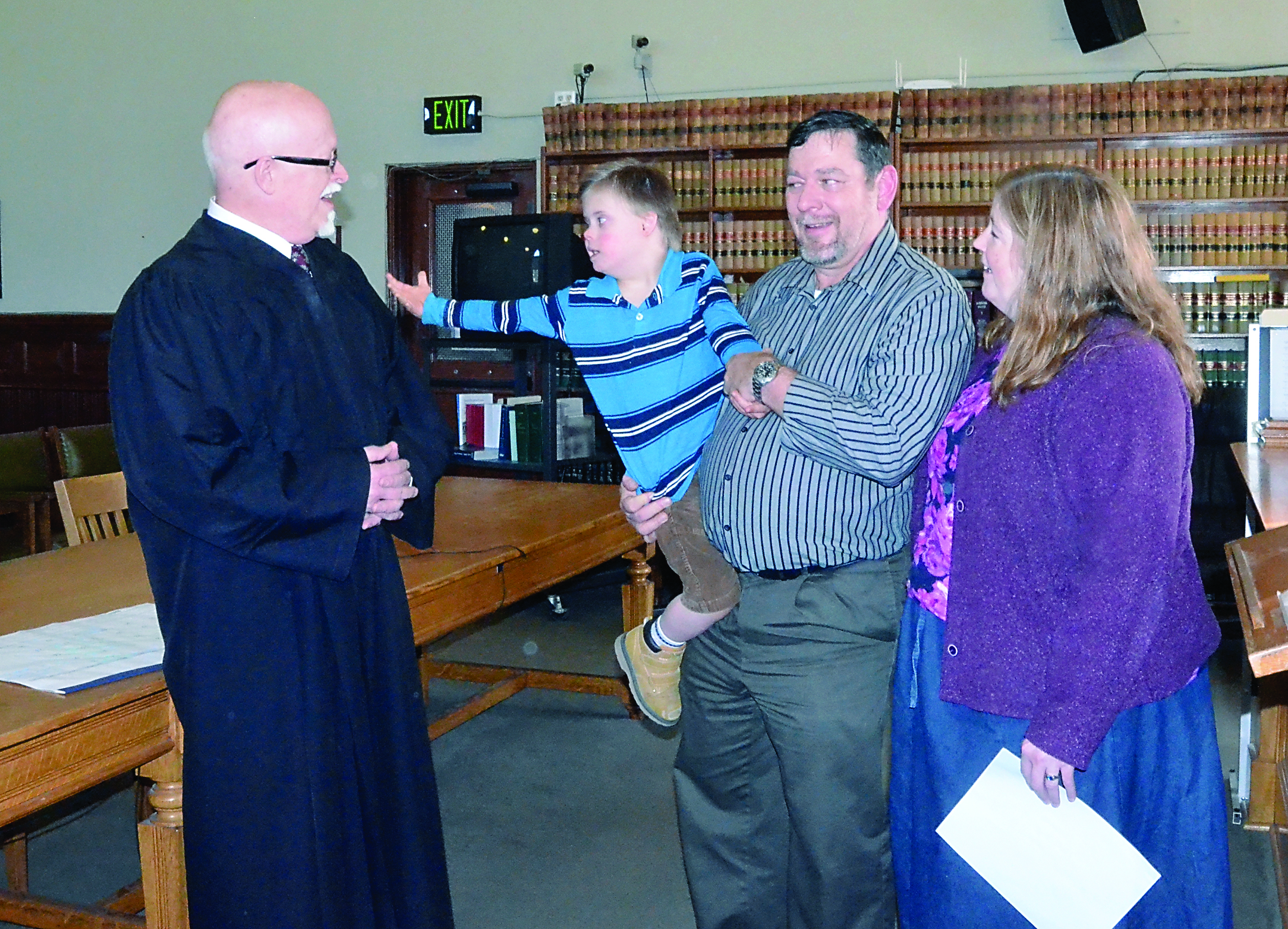 Eight-year-old Max Burger throws a stuffed bear in the Jefferson County Superior Court courtroom Thursday after an adoption ceremony presided over by Court Commissioner Steven Gillard