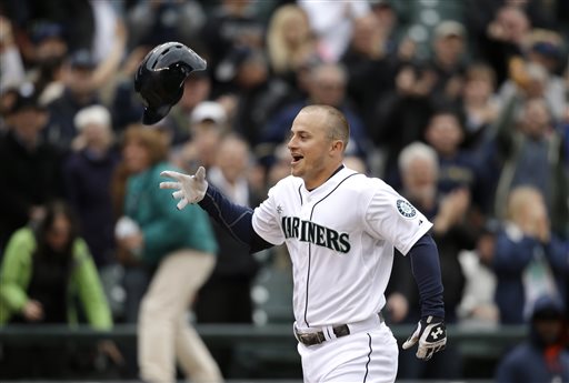 Seattle Mariners' Kyle Seager tosses his batting helmet as he heads home on his three-run walk-off home run against the Houston Astros in the ninth inning of a baseball game in Seattle last April. —Photo by Elaine Thompson/The Associated Press