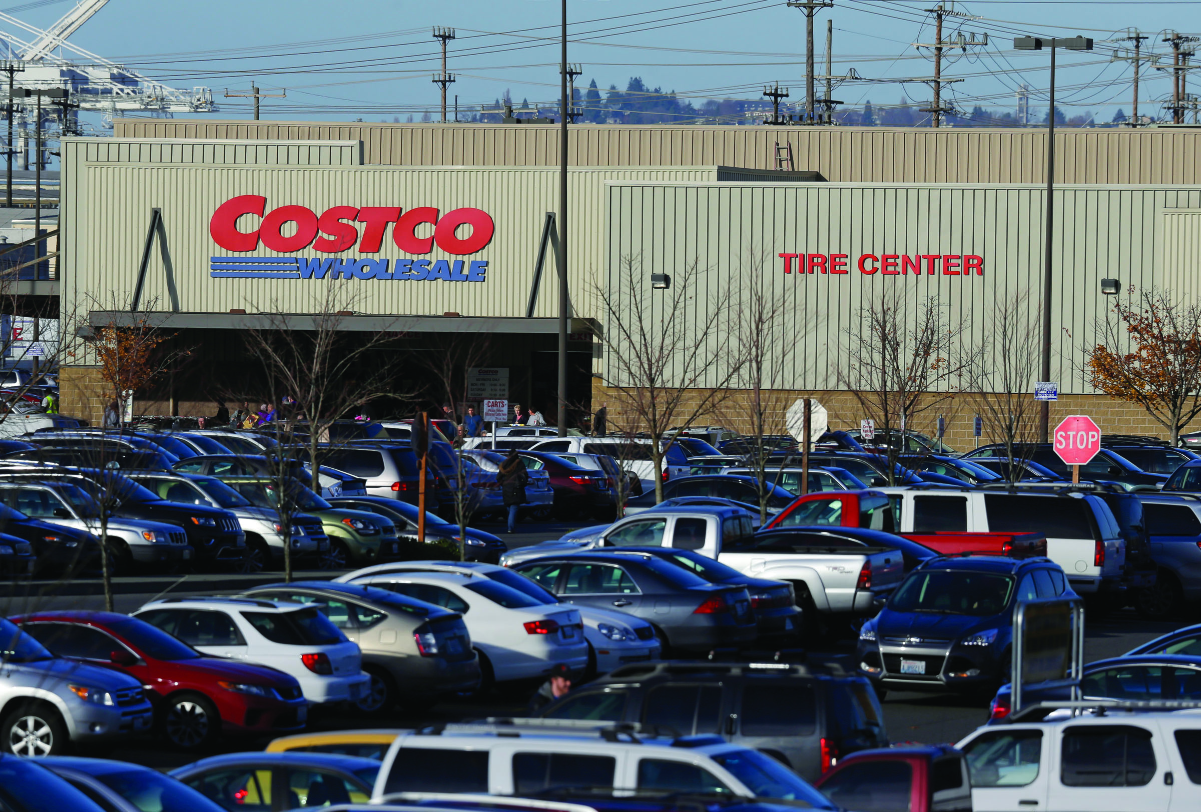 Cars fill the parking lot of a Costco store in Seattle on Tuesday. Health authorities said chicken salad from Costco has been linked to at least one case of E. coli in Washington state. — The Associated Press