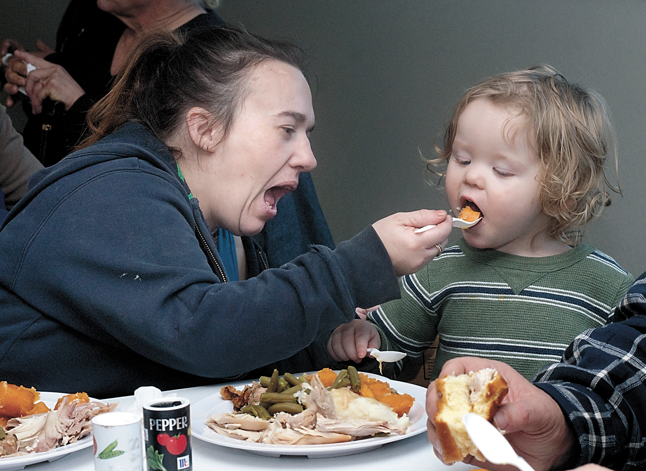 Crystal Holmberg of Port Angeles feeds yams to her son