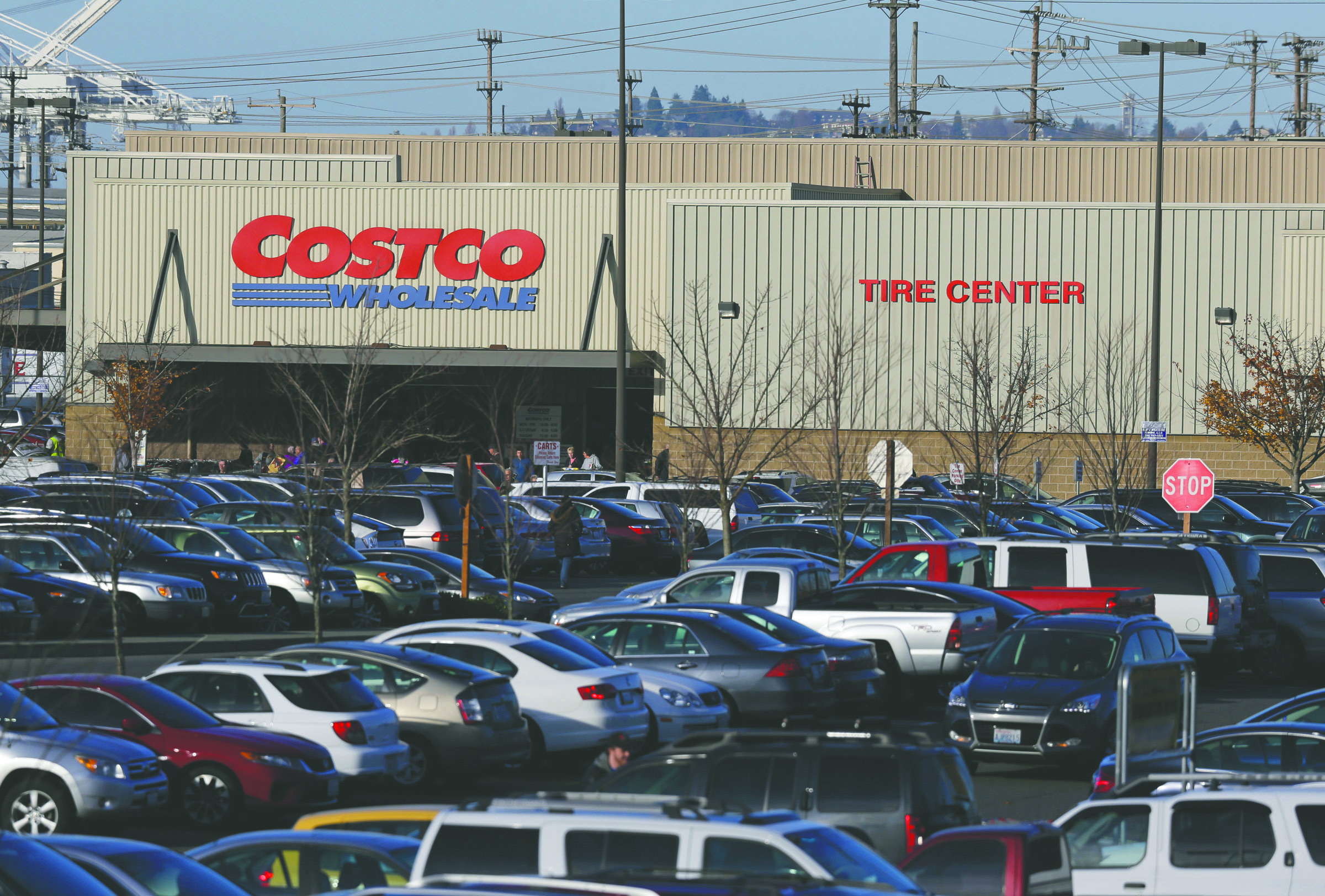 Cars fill the parking lot of a Costco store Tuesday in Seattle. Health authorities say chicken salad from Costco has been linked to at least one case of E. coli in Washington state. The Associated Press
