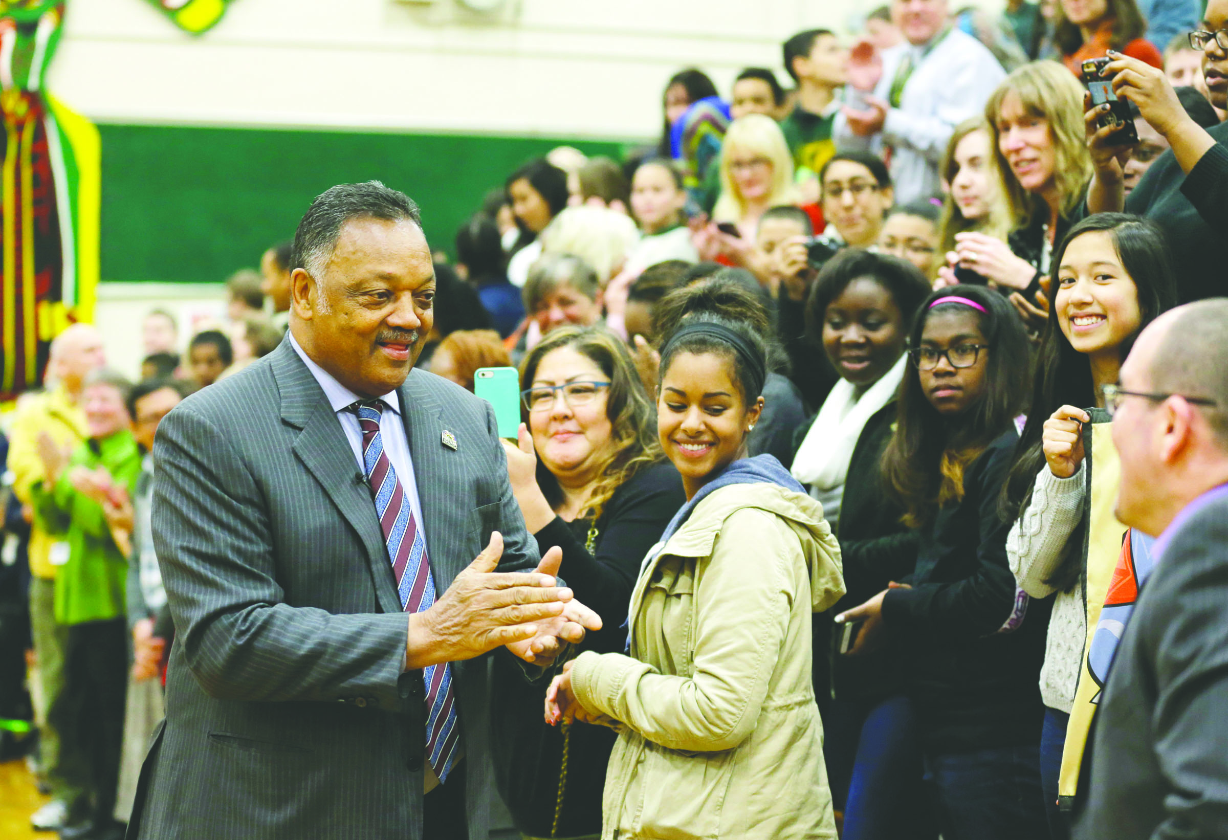 The Rev. Jesse Jackson arrives to talk to students and teachers at an assembly Monday at the Technology Access Foundation Academy in Kent. The Associated Press