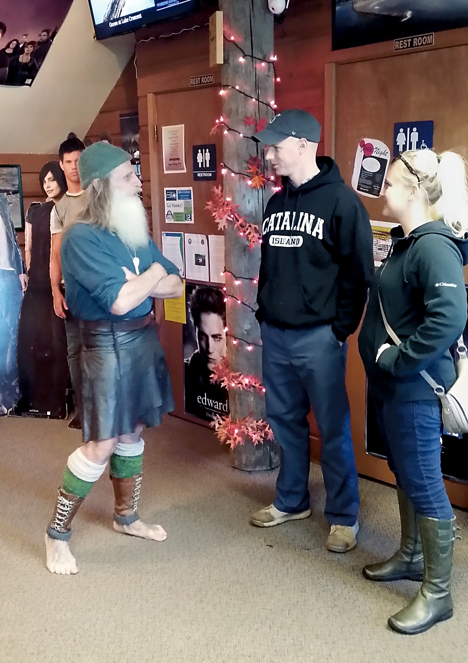 Danica and Hank Christiansen speak with Mick Dodge at the Forks Visitor Information Center. — Forks Chamber of Commerce