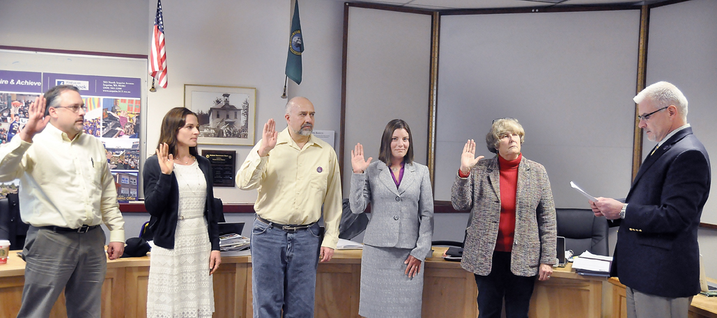 Five Sequim School Board members were sworn in during a ceremony at the beginning of their meeting Monday. From left are board members Mike Howe