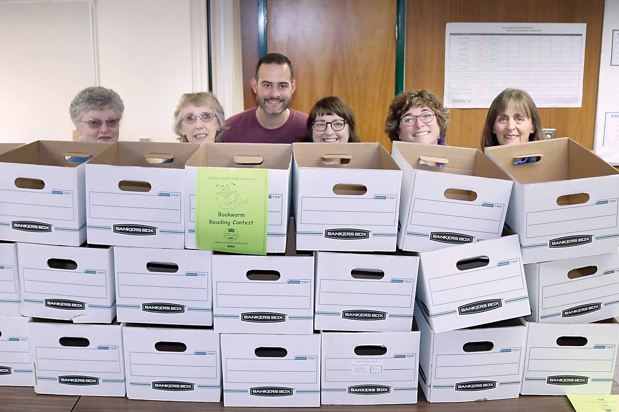 Clallam County Literacy Council volunteers prepare to fill boxes with books for delivery to participating sites. From left are JoAnn Thomson