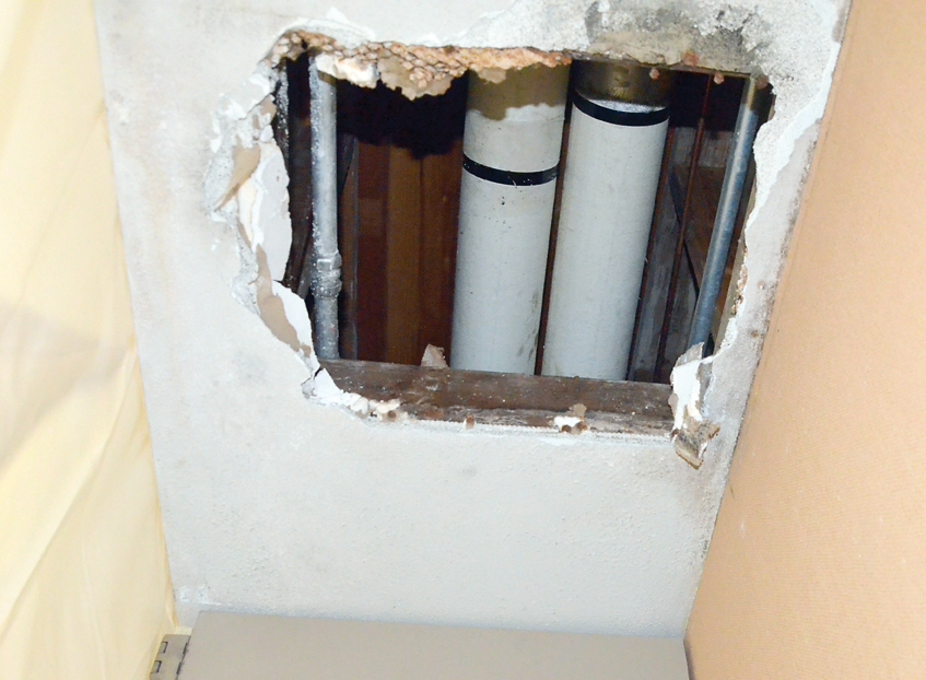 A leaky pipe in a closet ceiling at Grant Street School represents one of the small problems the aging building can expect in the next few years. Charlie Bermant/Peninsula Daily News