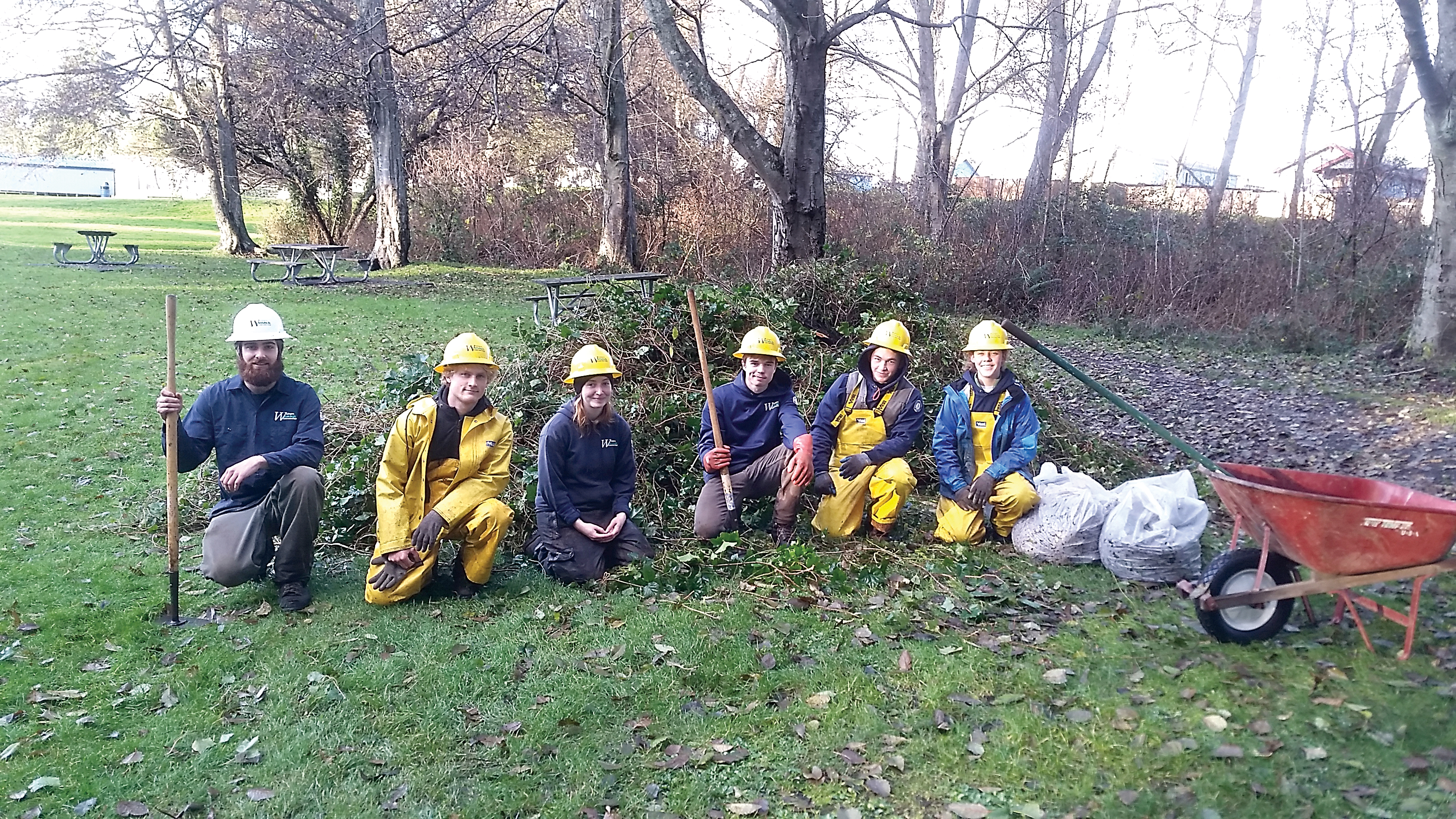 The Puget SoundCorps Team in front of one of many piles of invasive ivy removed from Shane Park in Port Angeles.