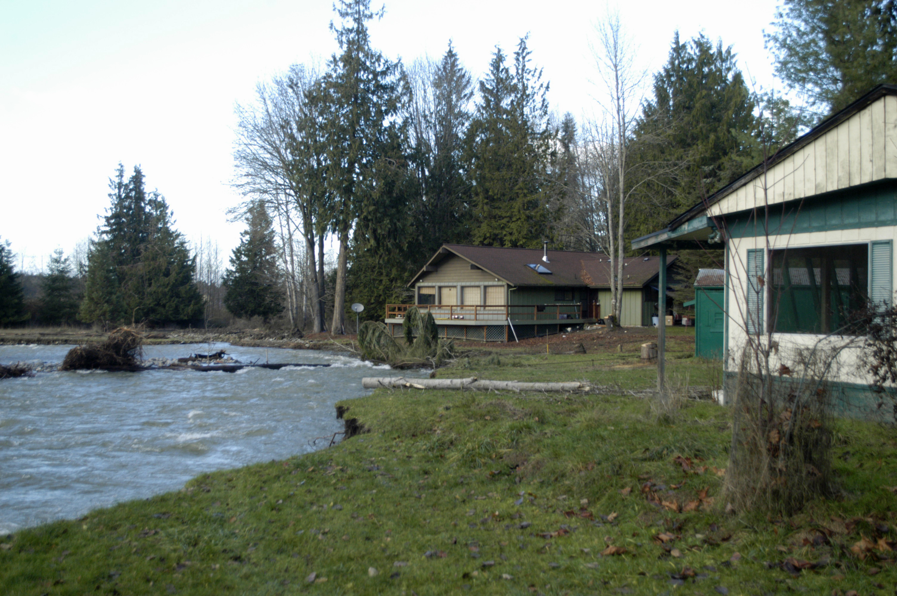 These two homes in the 100 block of Serenity Lane southwest of Sequim are in the process of being purchased by the Jamestown S'Klallam tribe using grant money. The houses are in a natural floodplain of the Dungeness River and will be demolished to restore a natural habitat for salmon. Chris McDaniel/Peninsula Daily News