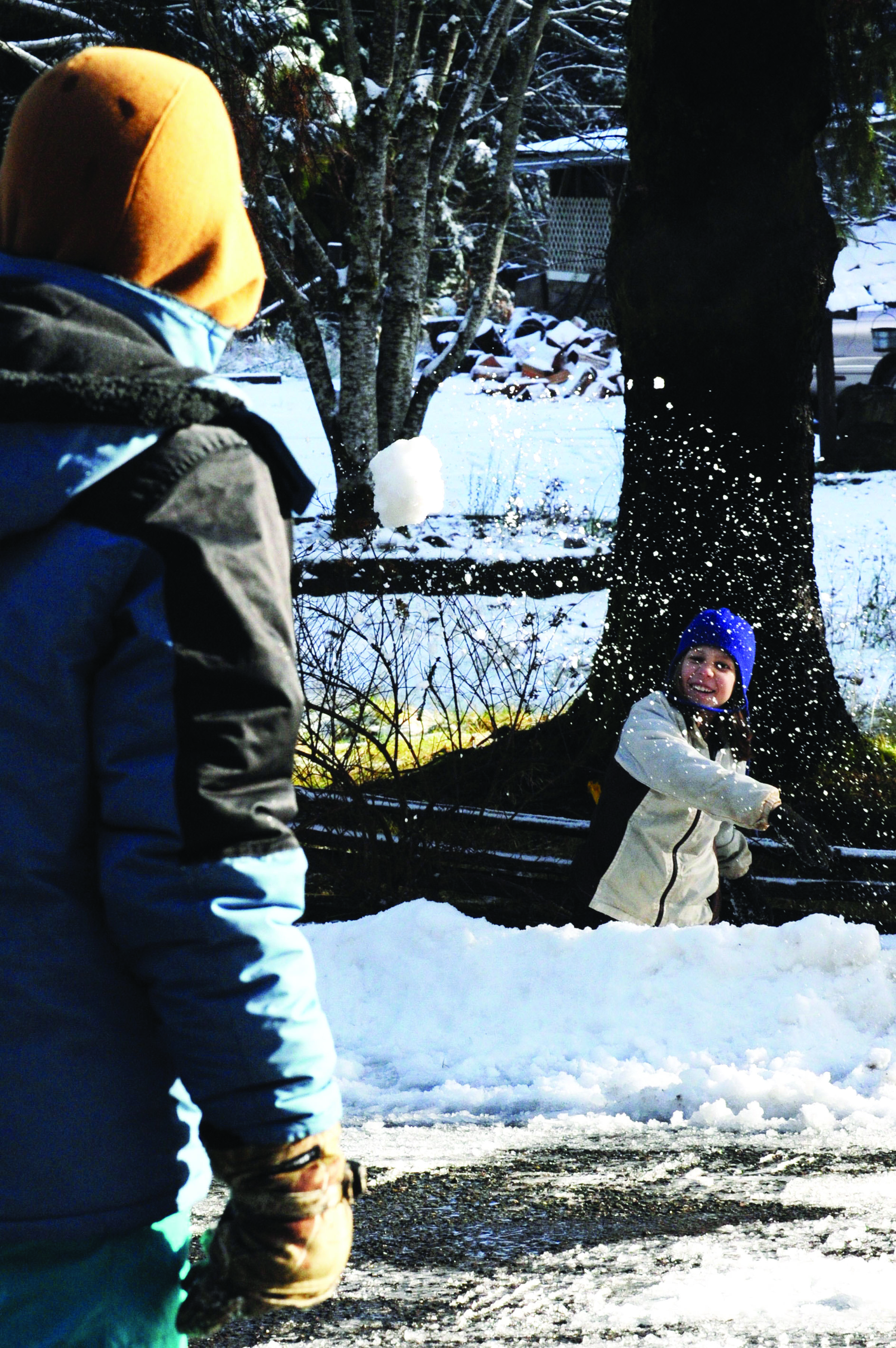 A snowball is chucked from a partially built fort by Melyssa Whiting