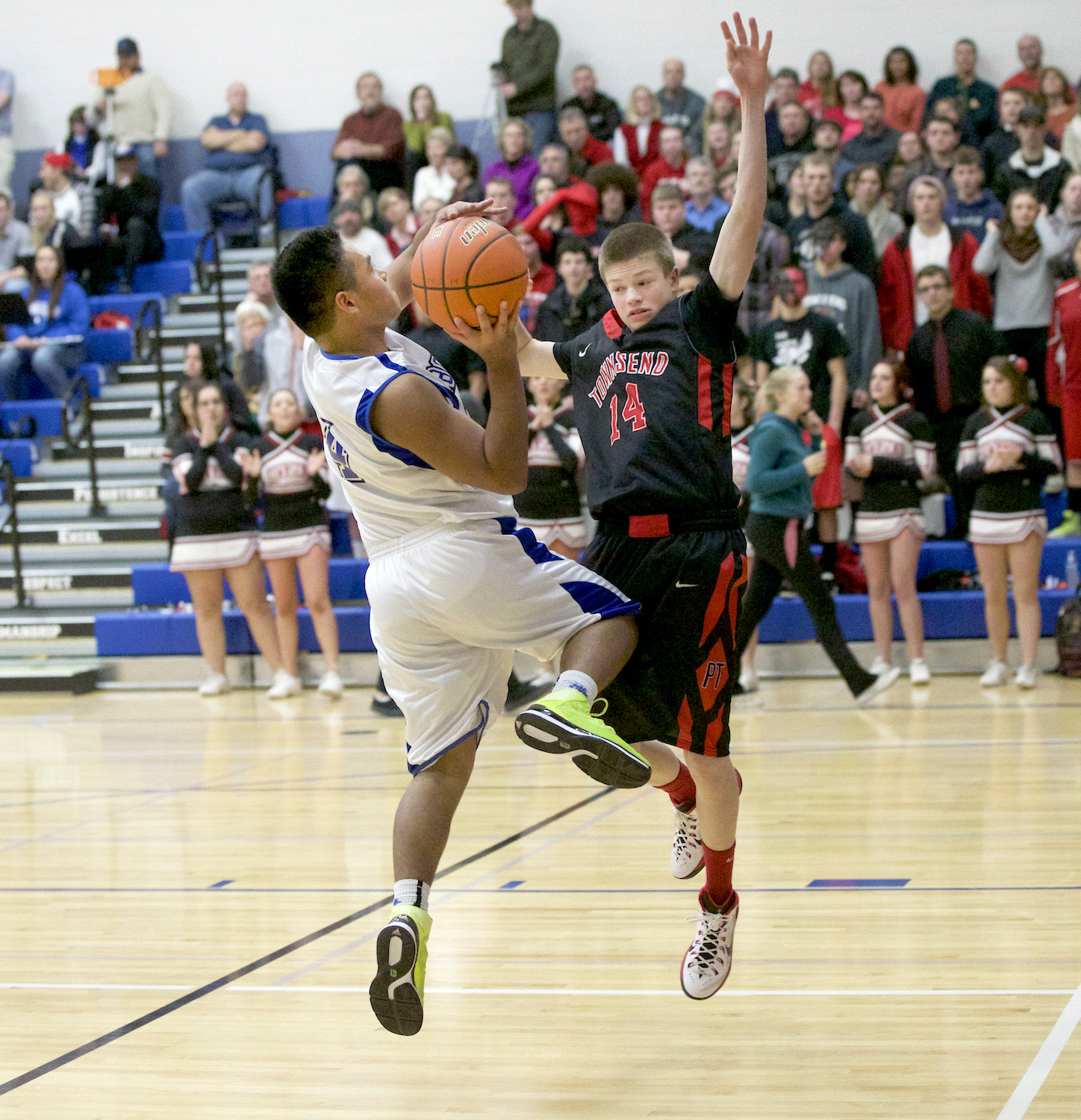 Chimacum's Victor Hitt goes up for a basket and gets fouled by Port Townsend's Berkley Hill (14) during the Cowboys' home win over the Redhawks. Steve Mullensky/for Peninsula Daily News