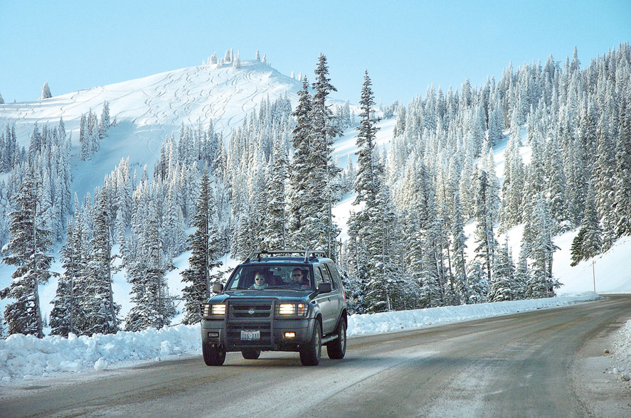 A motorist drives down Hurricane Ridge Road in 2010. Peninsula Daily News