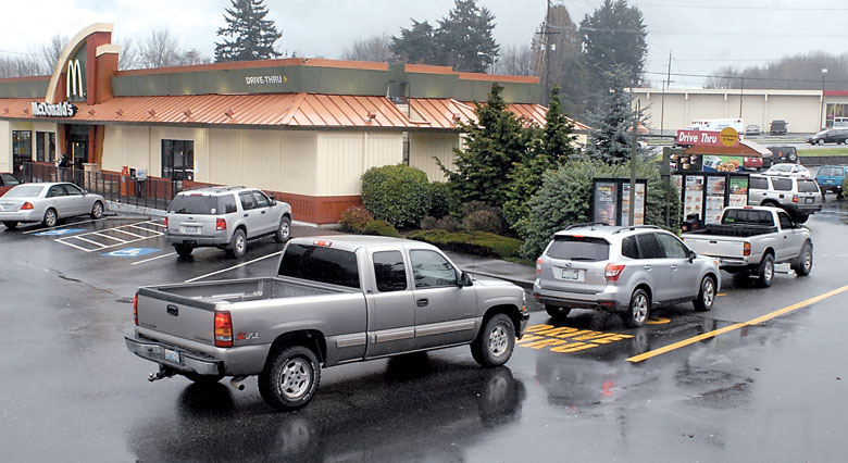 Vehicles line up for the drive-through window at the Port Angeles McDonald’s restaurant on Thursday. Plans call for construction of a new restaurant with two longer drive-through lanes. — Keith Thorpe/Peninsula Daily News