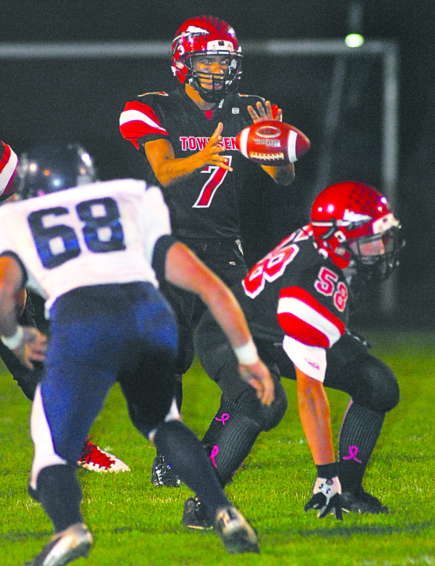 Port Townsend quarterback Jacob King (7) takes a snap and teammate Keegan Khile (58)