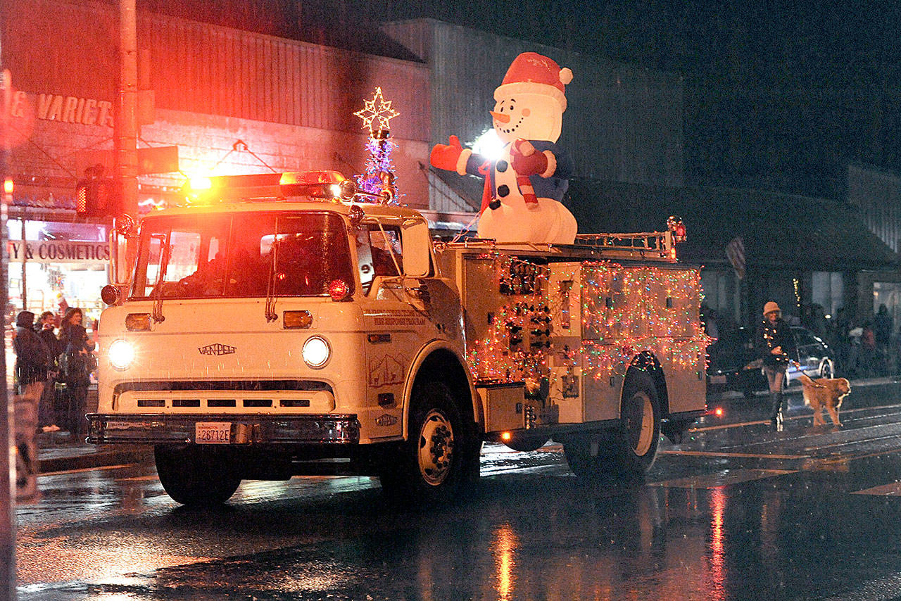 The Olympic Correction Center’s Fire Response Program’s entrée passes in the Twinkle Light Parade last year in Forks. (Lonnie Archibald/for Peninsula Daily News)