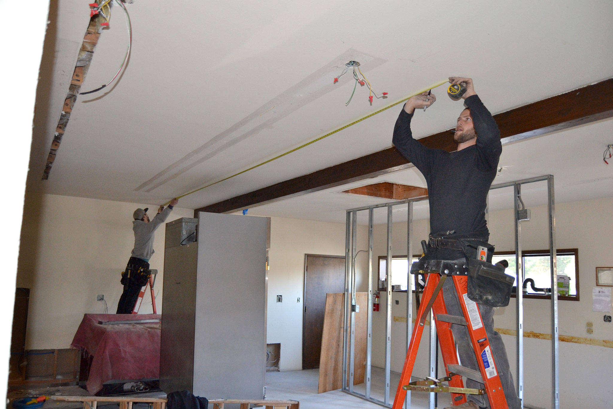 <strong>Matthew Nash</strong>/Olympic Peninsula News Group                                Tyler Philp, left, and Tyler Wickersham with North Peninsula Electric take measurements for new lighting inside the Guy Cole Convention Center’s commercial kitchen.