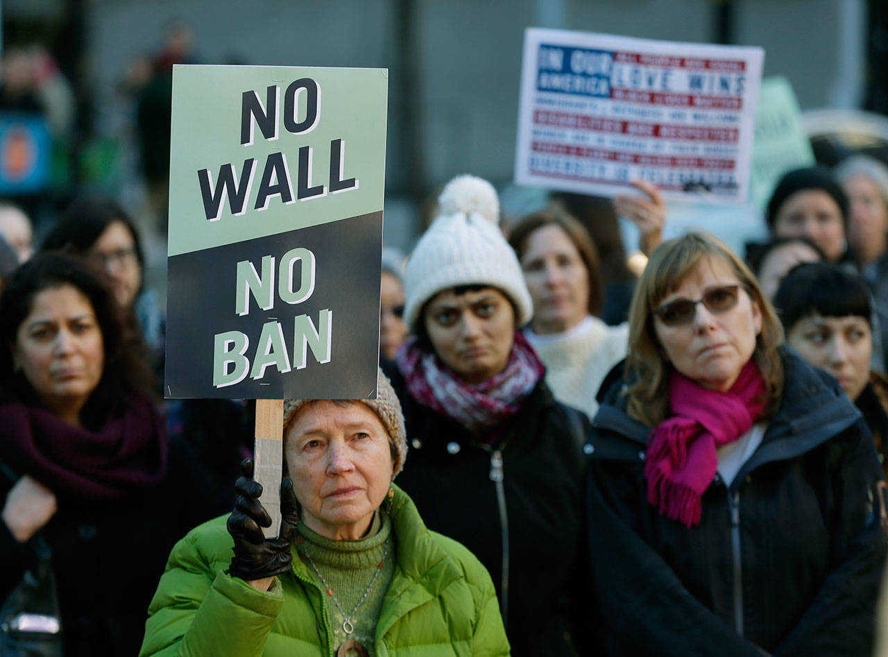 Annie Phillips, of Burien holds a sign that reads “No Wall No Ban,” during a protest, Wednesday outside a federal courthouse in Seattle. (Ted S. Warren/The Associated Press)