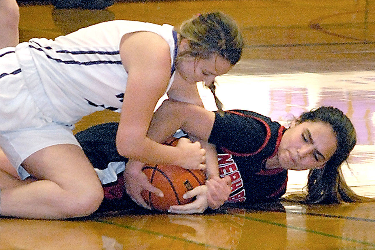 Keith Thorpe/Peninsula Daily News Sequim’s Bobbi Sparks, top, and Neah Bay’s Courtney Swan battle for a loose ball in the closing minutes of Tuesday night’s matchup at Sequim High School.