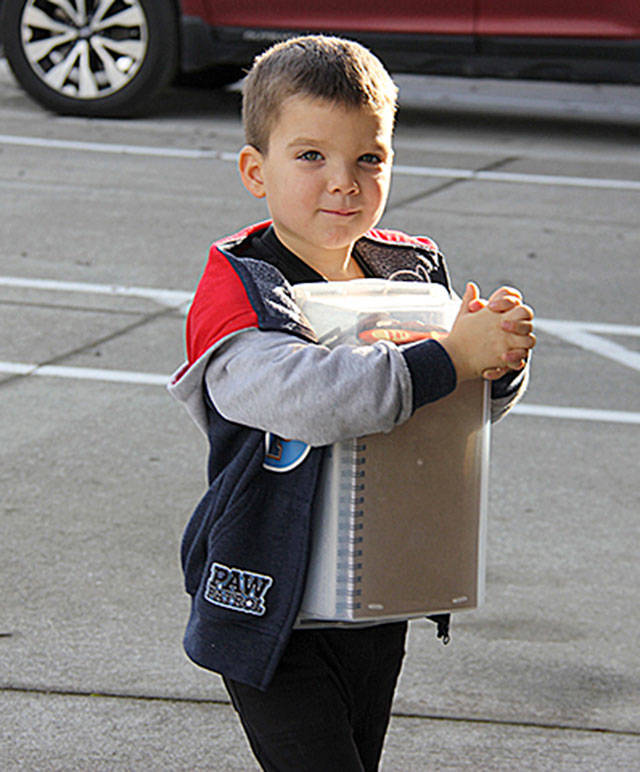 Wade McCarthey of Sequim brings his shoebox to Eastern Hills Community Church during Operation Christmas Child Collection Week.