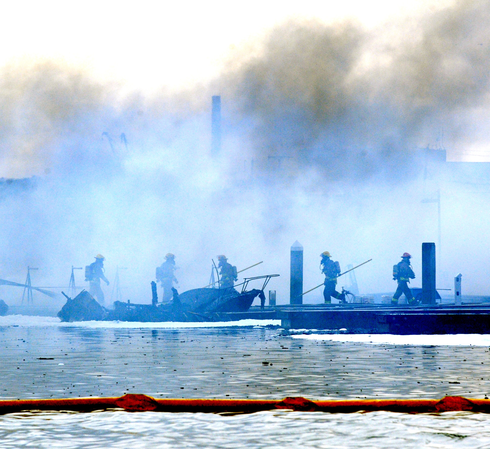 Multiple boats were destroyed after a fire broke out Friday morning in a boathouse on the East G dock at Squalicum Harbor in Bellingham. The Bellingham Herald via Associated Press