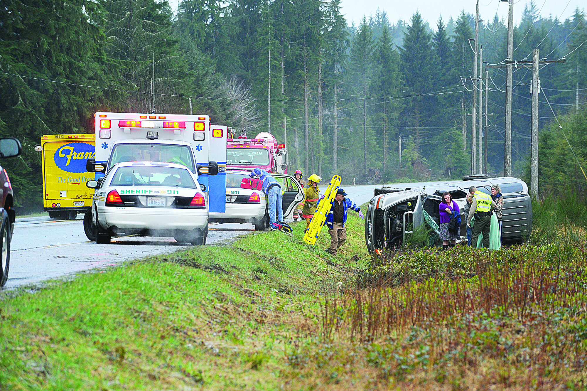 State Patrol and Clallam County Sheriff and Fire Department personnel respond to a rollover accident that occurred Tuesday morning. Lonnie Archibald/for Peninsula Daily News