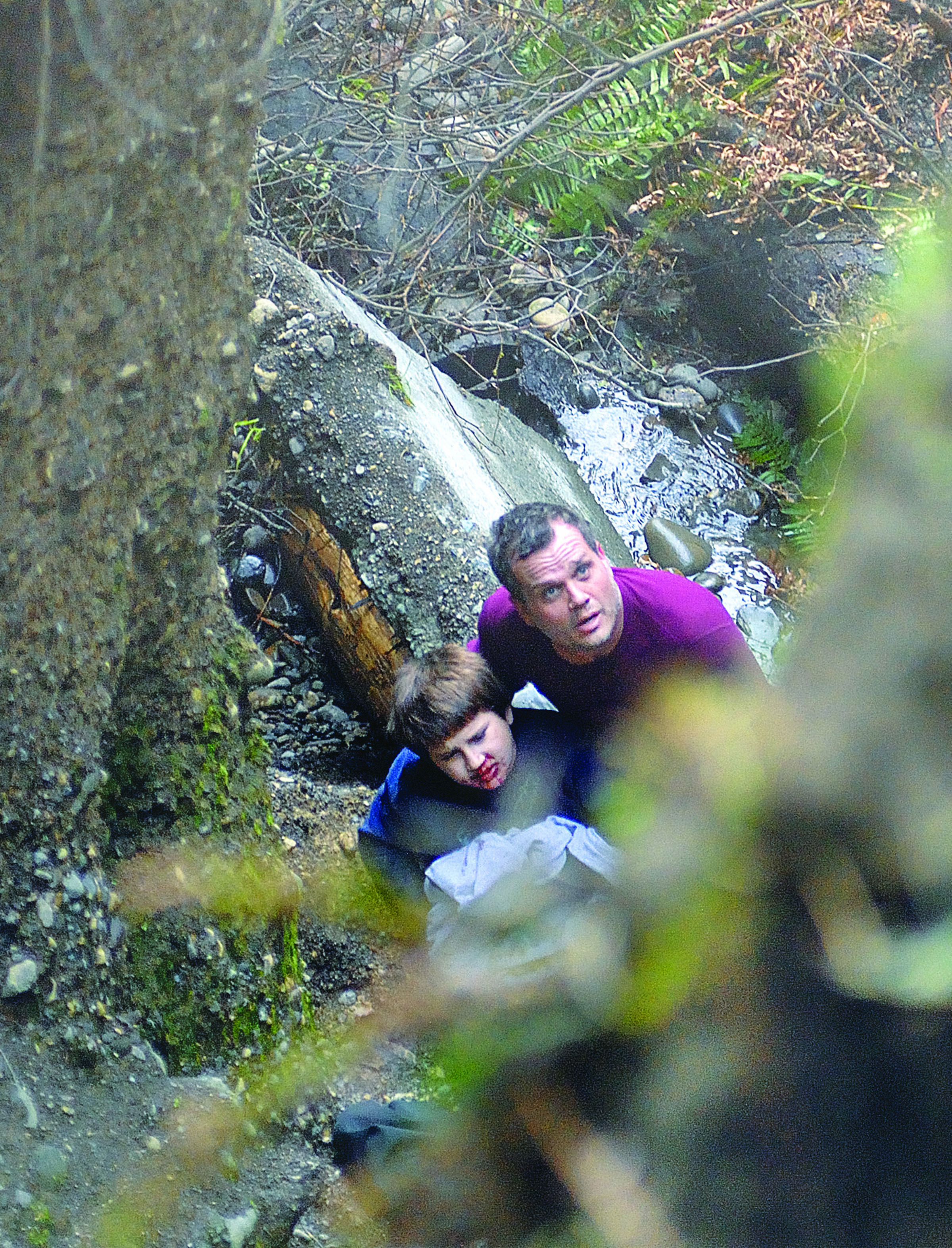 David Jangula holds a boy identified only as Justice who fell down a bluff in west Port Angeles. -- Photo by Chris Tucker/Peninsula Daily News