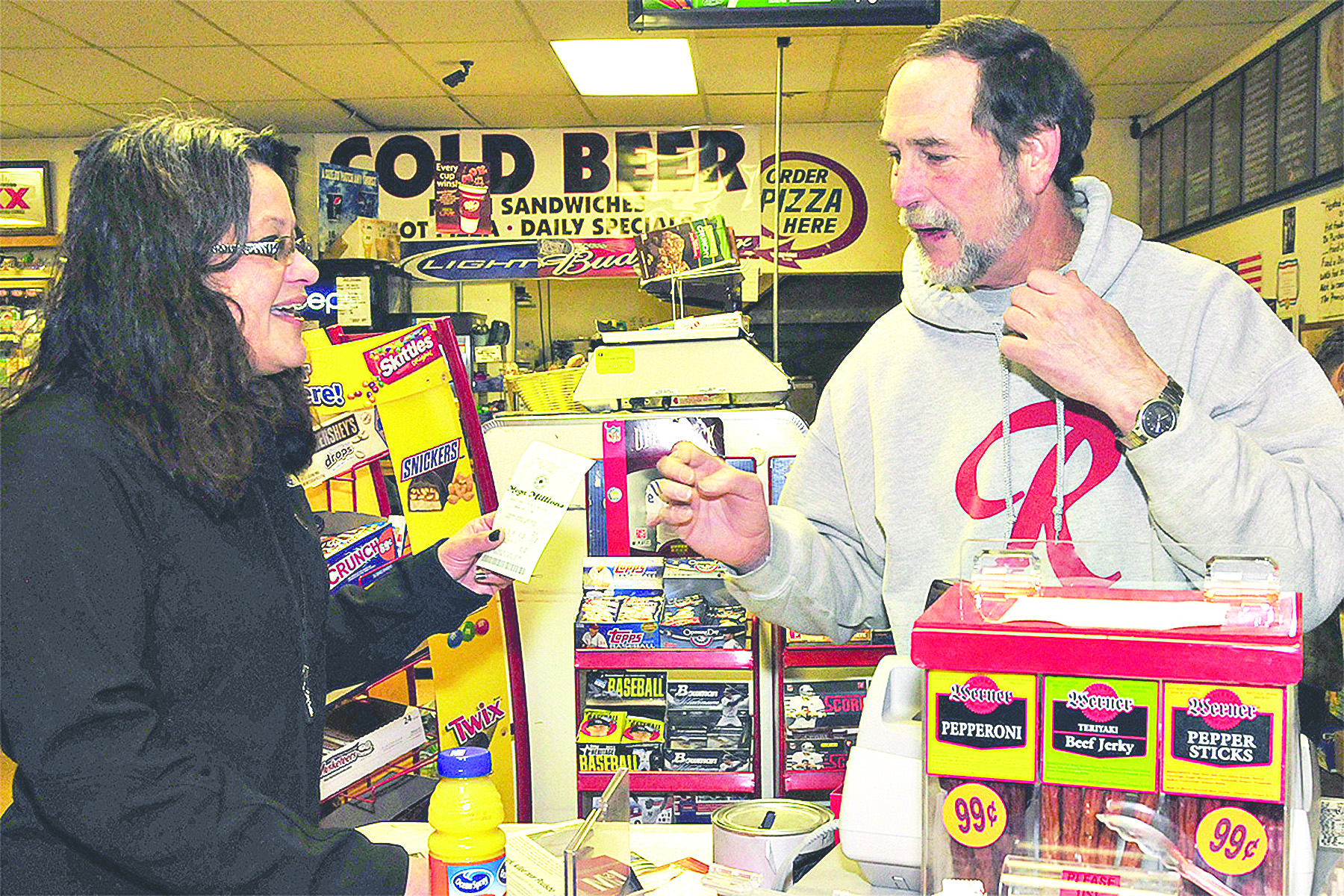 Billie Meyers buys a Mega Millions ticket from Pennysaver cashier Roger Ramey