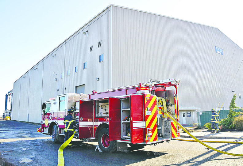 Westport Shipyard employees gather in the parking lot after a chemical spill was reported at the factory Wednesday morning in Port Angeles. Chris Tucker/Peninsula Daily News