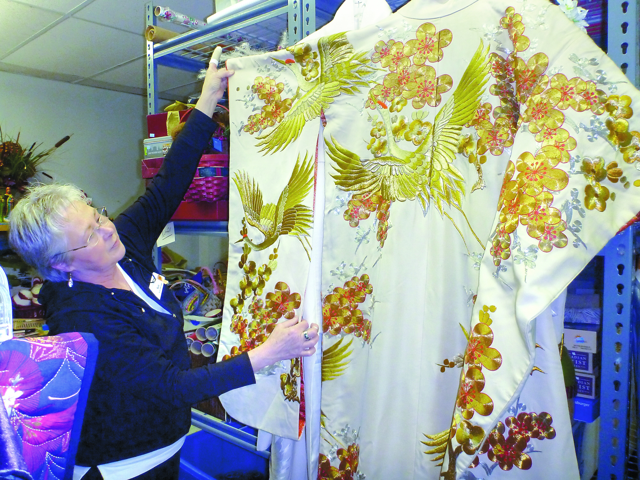 Sue Garlinghouse shows off the wedding kimono donated by Jeannette Hall of Quilcene. Jennifer Jackson/for Peninsula Daily News