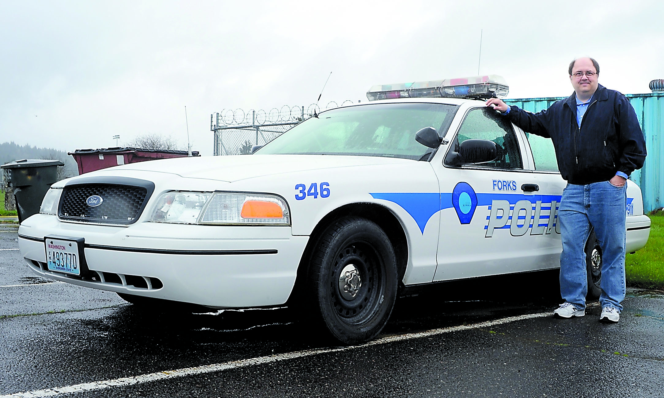 Forks Mayor Bryon Monohon stands next to a Forks squad car at the city police station. A company called GreenLight collectibles wants to miniaturize the cars as part of its "Hollywood Series." Lonnie Archibald/for Peninsula Daily News