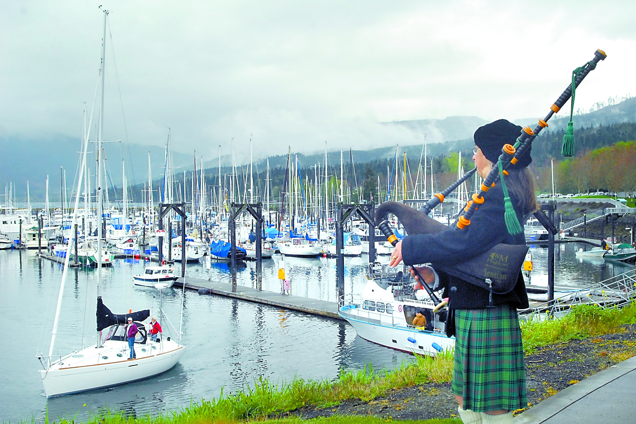 Bagpiper Nancy Fredrick of Port Townsend plays from the point overlooking the entrance to John Wayne Marina in Sequim to celebrate the opening day of boating season in 2011. Keith Thorpe/Peninsula Daily News