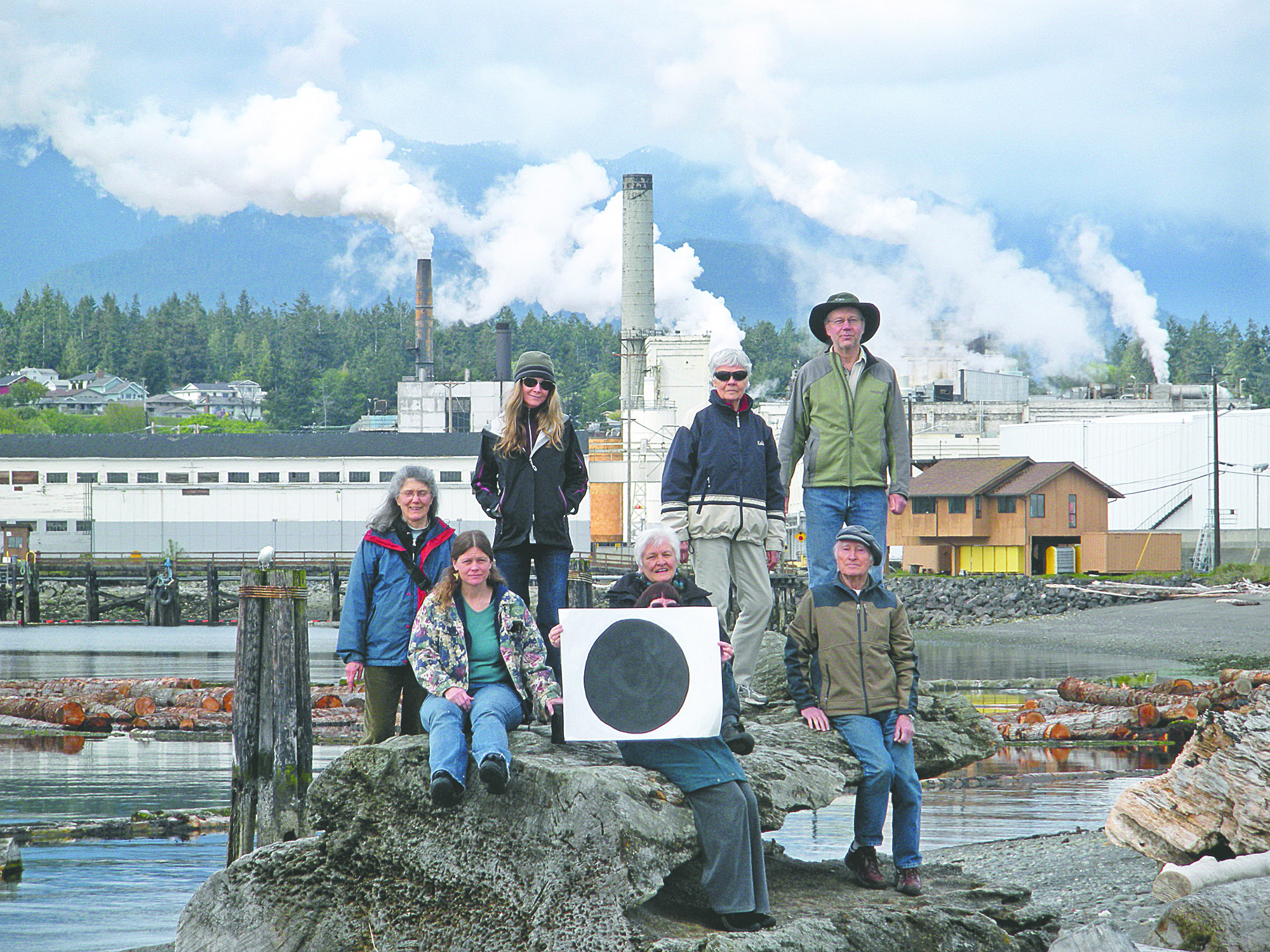 Environmentalists pose with their "dot" in front of the Nippon paper mill in Port Angeles. The photo appears on climatedots.org.