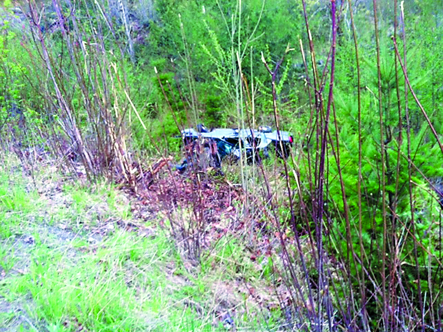 A State Patrol car lies on its side in a ravine off Deer Park Road in Port Angeles Wednesday. Clallam County Fire District No. 2