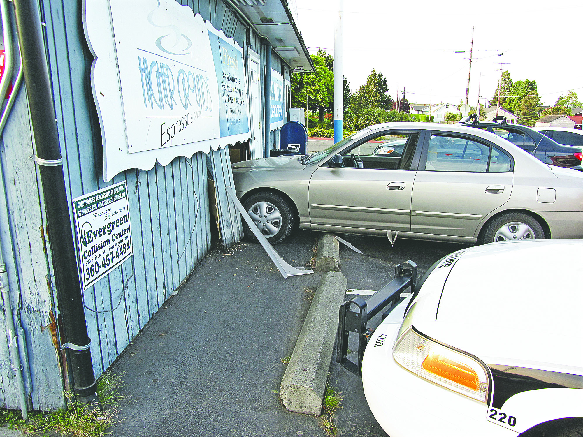 A car that crashed into the Grandview Grocery in Port Angeles is shown sitting across the concrete berm. The grocery reopened Wednesday. Cami Cromer
