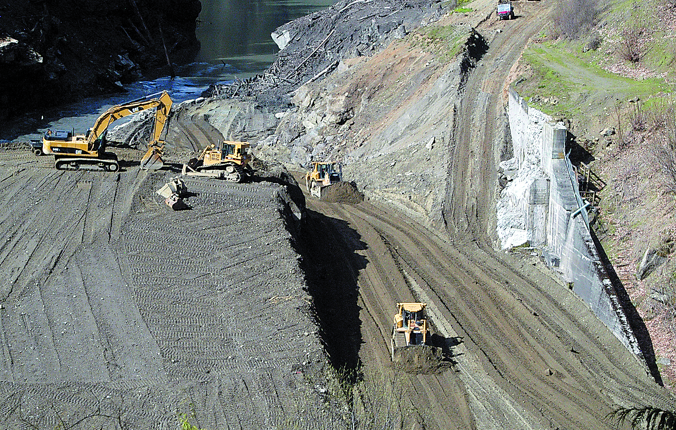 Bulldozers push dirt into what was once the spillway of the former Elwha Dam on Friday.  -- Photo by Keith Thorpe/Peninsula Daily News