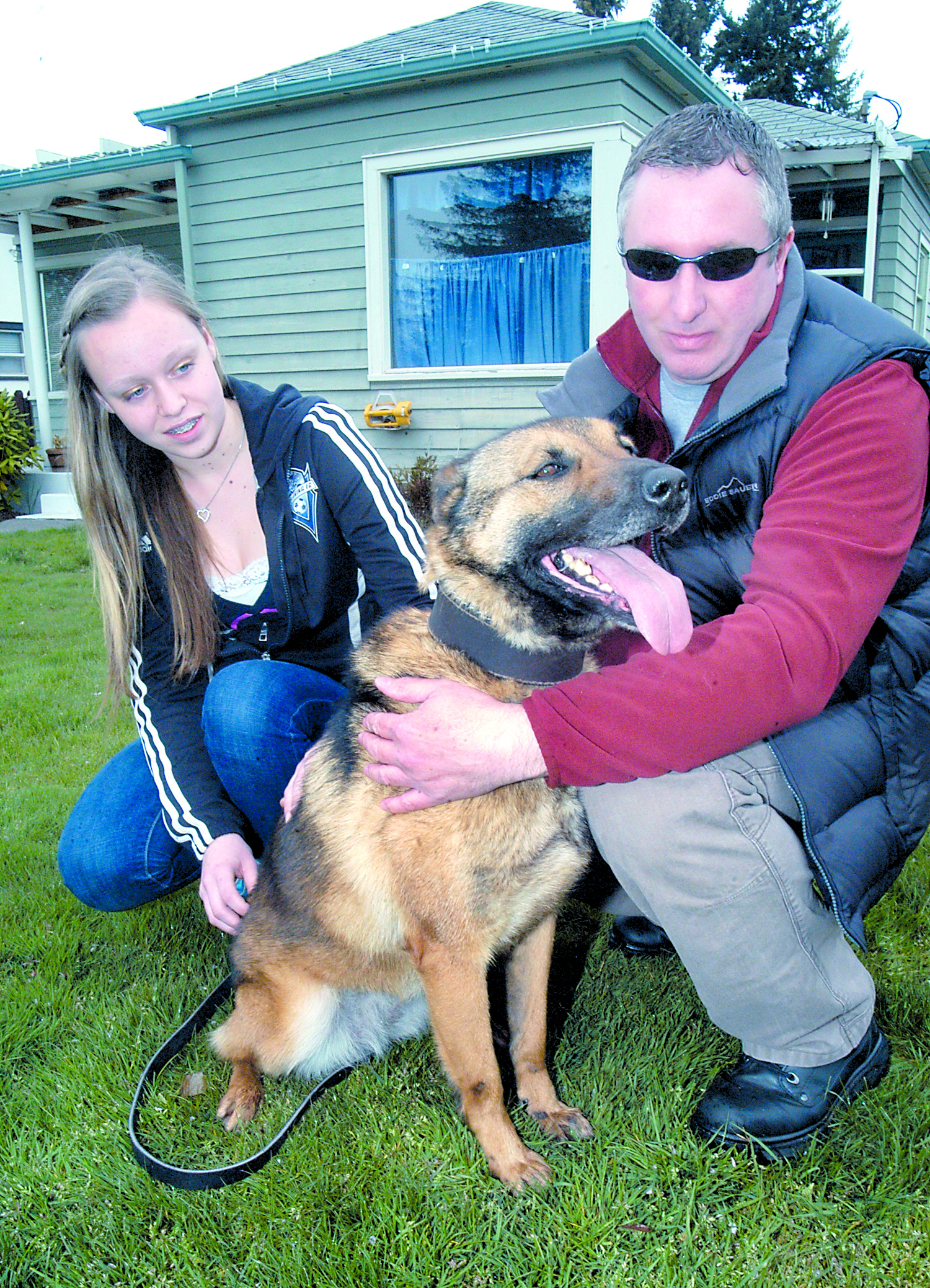 Mold-sniffing dog Zena is held by her owner
