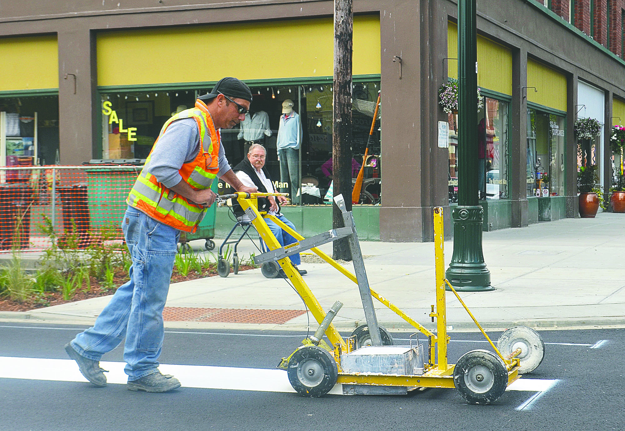 Jeff Enera provides the striping for the crosswalk at the intersection of Taylor Street and Water Street on Monday. The street is scheduled to open today.  -- Photo by Charlie Bermant/Peninsula Daily News