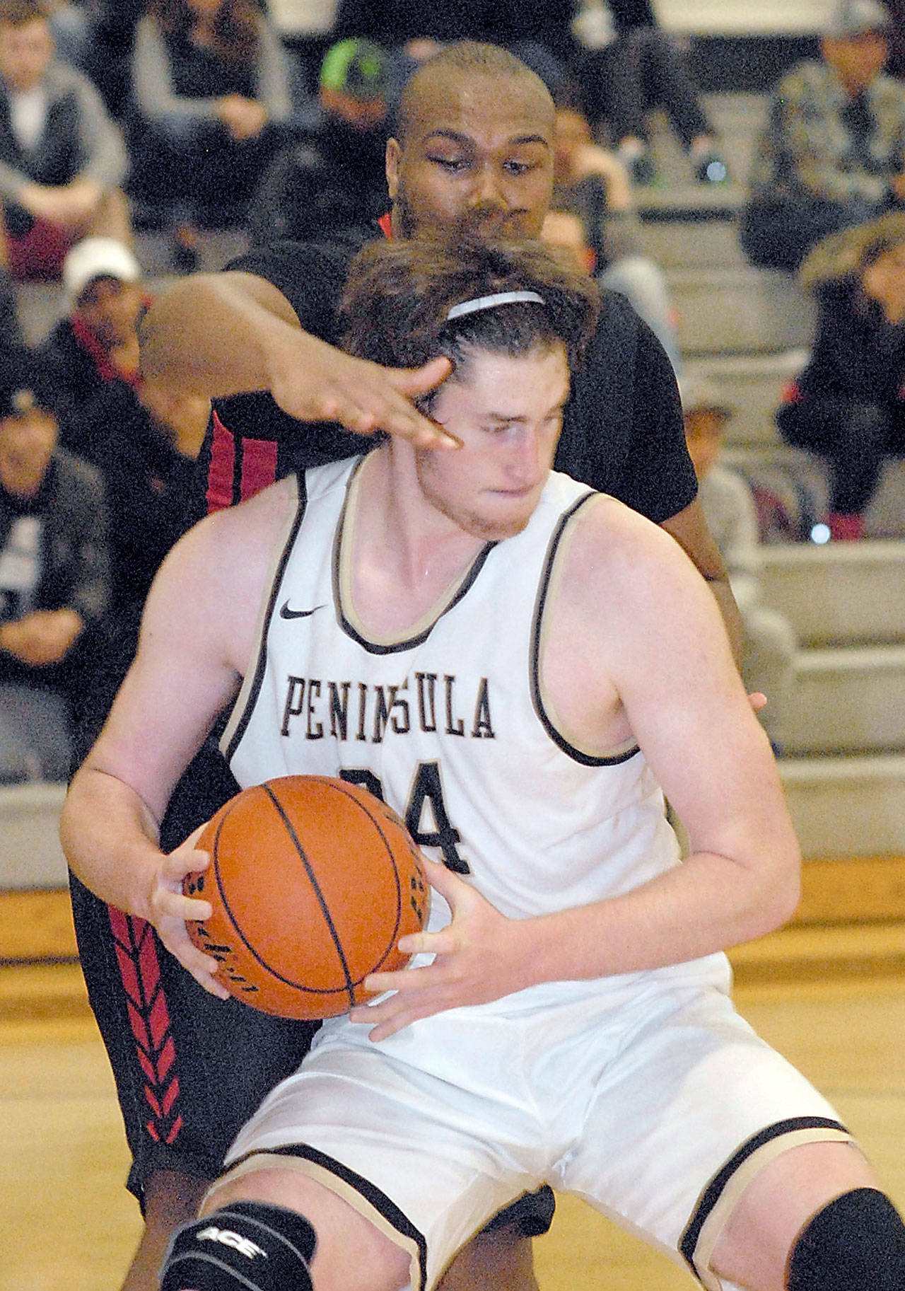 Keith Thorpe/Peninsula Daily News Peninsula’s Marky Adams tries to evade the defense of Mount Hood’s Terrell Walker during a November contest.