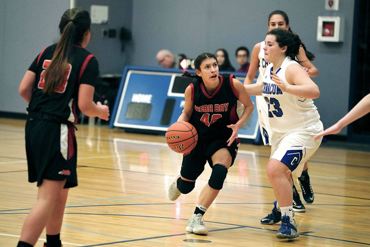 Steve Mullensky/for Peninsula Daily News Neah Bay’s Lalia Greene drives for the basket against Chimacum’s Jadeah Nordberg-Williams during a game on Wednesday in Chimacum.